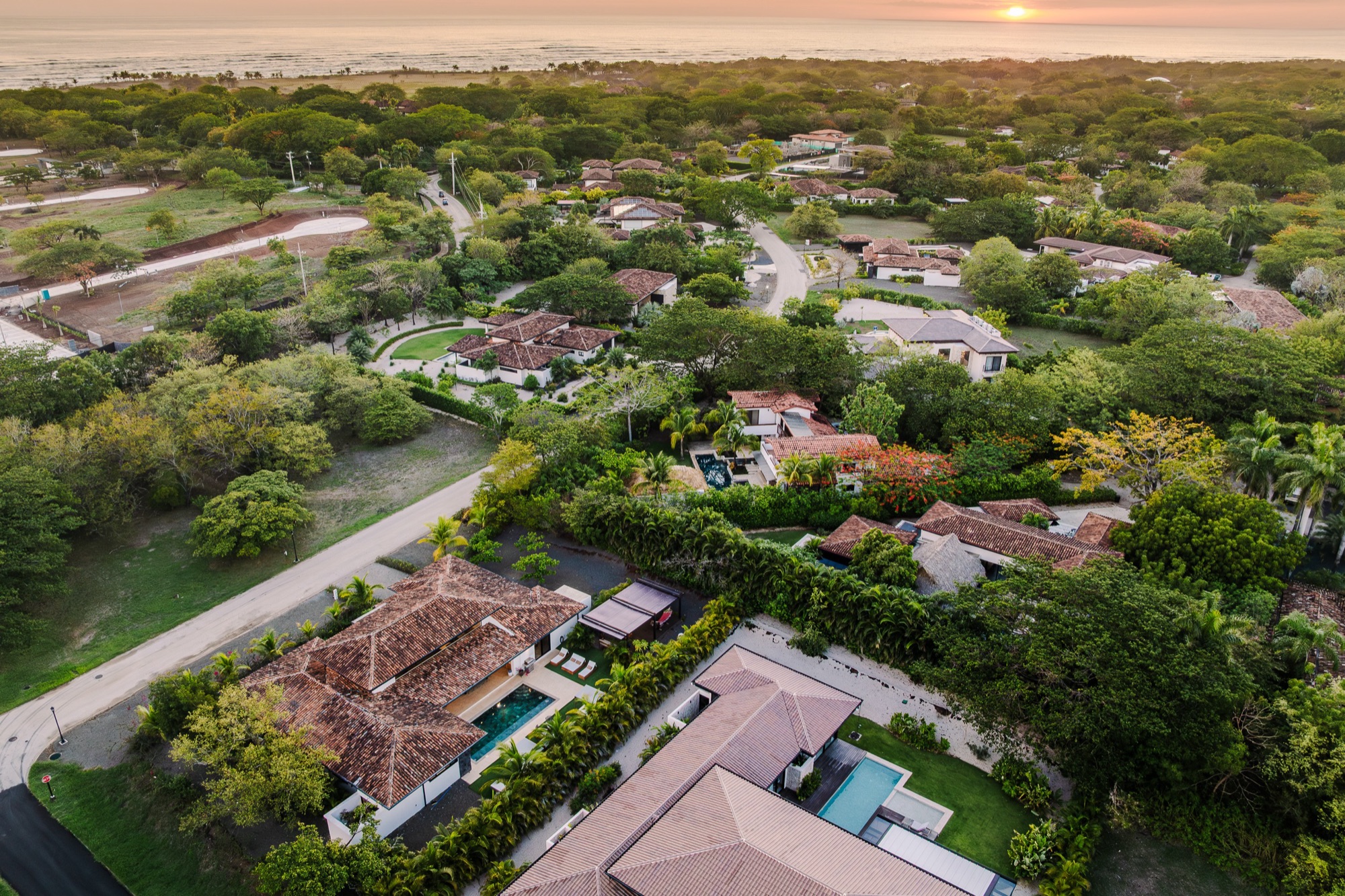 Villa Reserva 101 from above at sunset, the Pacific behind